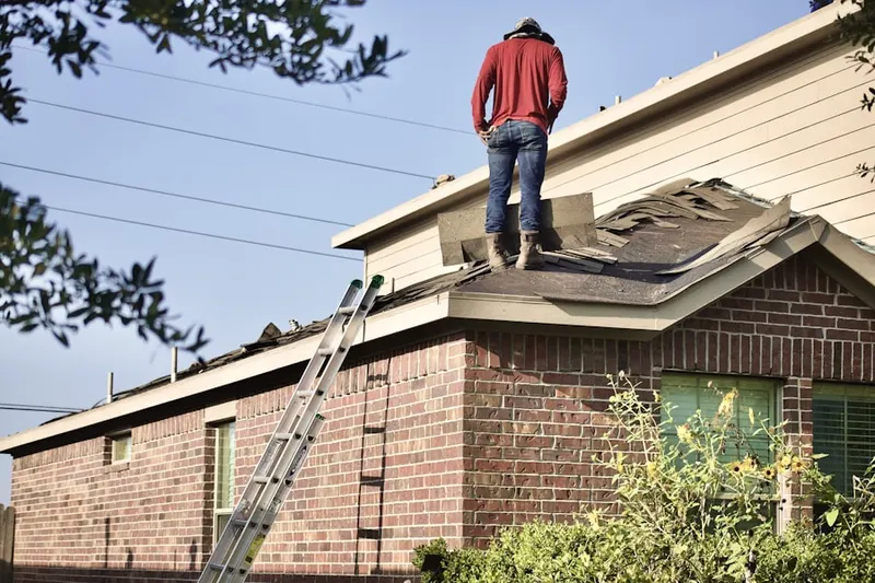 Professional roofer working on a residential roof in Joliet